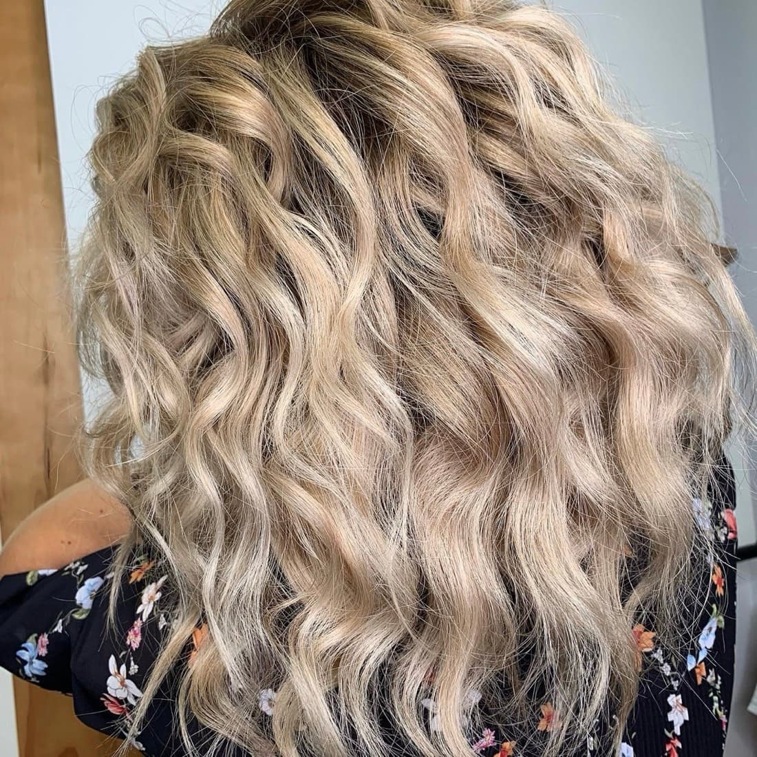 Beach-blonde balayage highlights in soft waves, colored at McAllister Spa's hair salon near South Beach