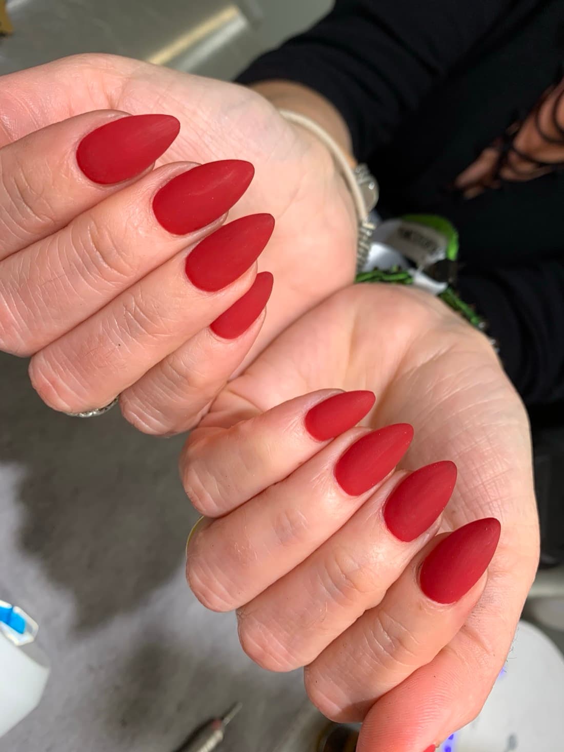 Matte red almond-shaped nails from a manicure at McAllister Spa's South Beach nail salon