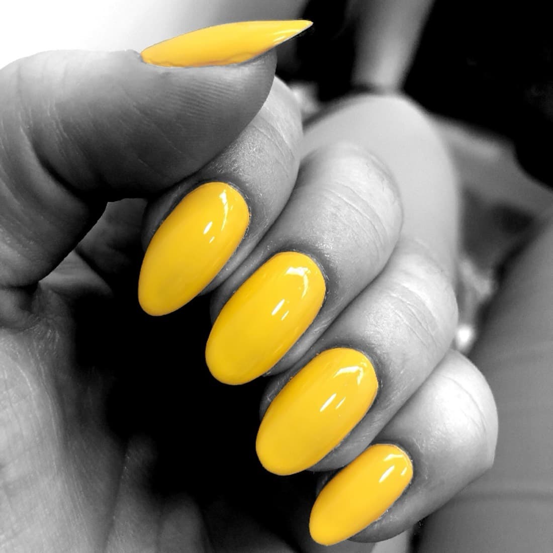 Yellow almond-shaped nails from a gel manicure at McAllister Spa's Miami Beach nail salon