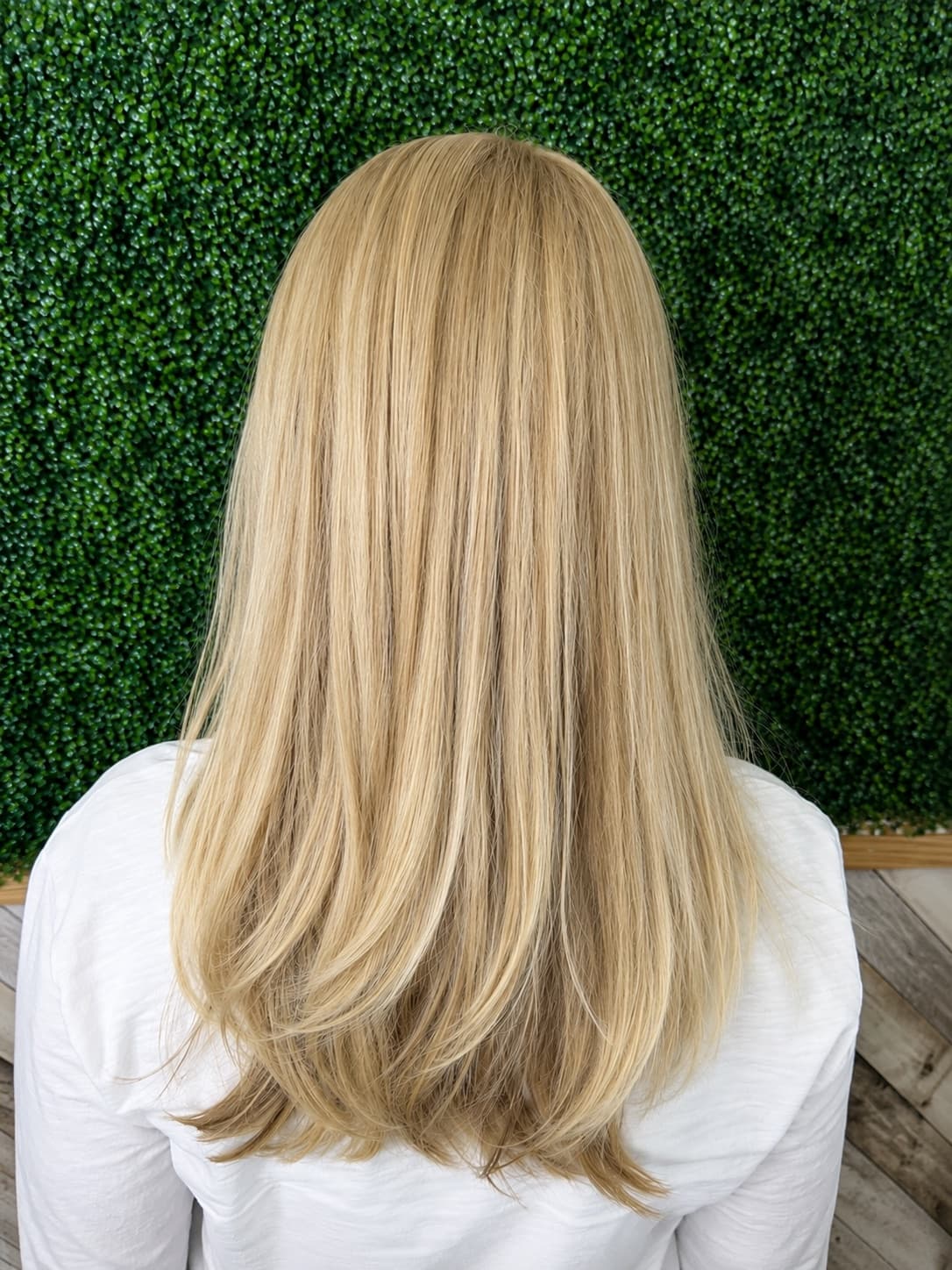 Long blonde hair with soft layers and a smooth blowout finish, hair color by McAllister Spa in South Beach