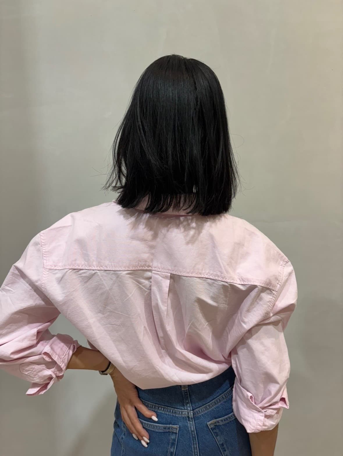 Before: a shoulder-length black blunt cut seen from behind, straight and one length at the collar — ahead of hair extensions by Hali at McAllister Spa in Miami Beach